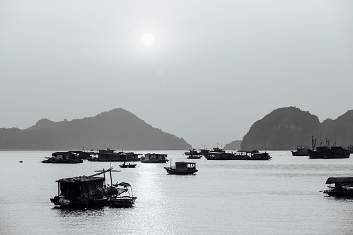 Asian fishing boats at sunset on a background of mountains. Ssunset.