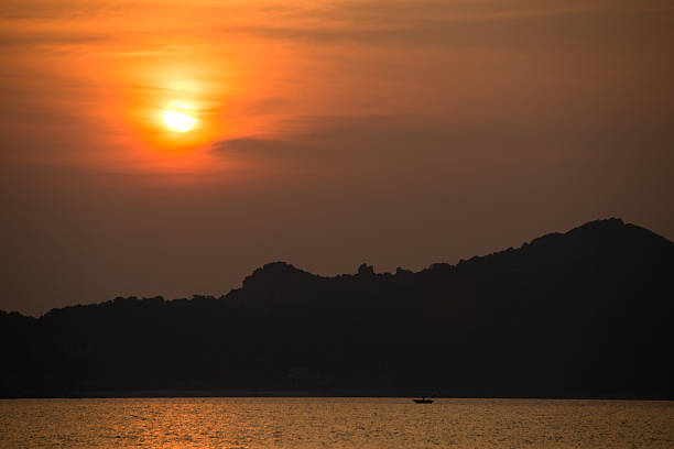 istock SUNSET over the forest. Glare on water, background 636744304
