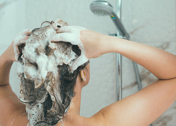 istock Woman washing her head in the shower. 636745876
