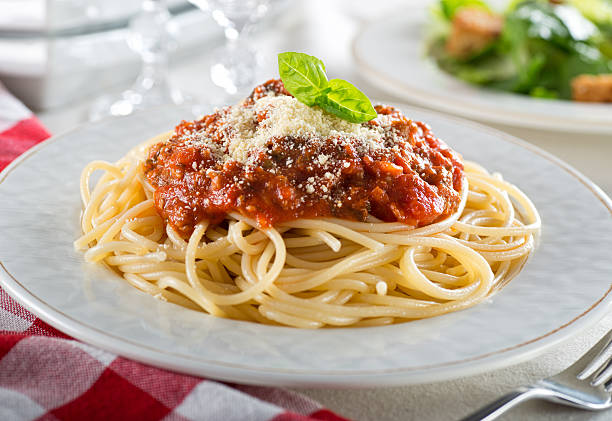 Spaghetti Bolognese A plate of delicious spaghetti bolognese with meat sauce and fresh basil. spaghetti photos stock pictures, royalty-free photos & images