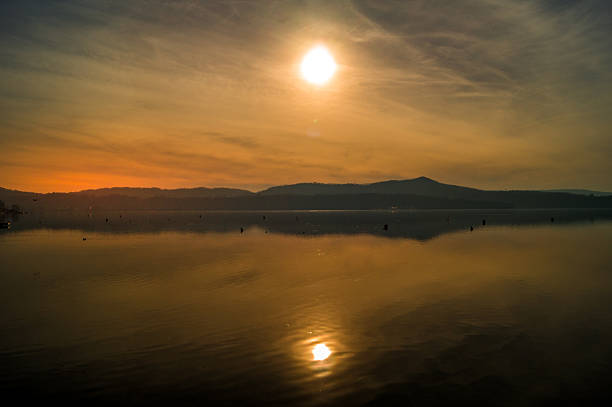 istock Sunset on lake, with mountains and snow on background 636747578