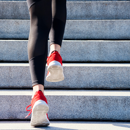 High intensity training (HIIT) of a female sportswoman at a staircase - blurred motion