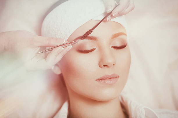 istock Beautiful young woman gets eyebrow correction procedure 636749288