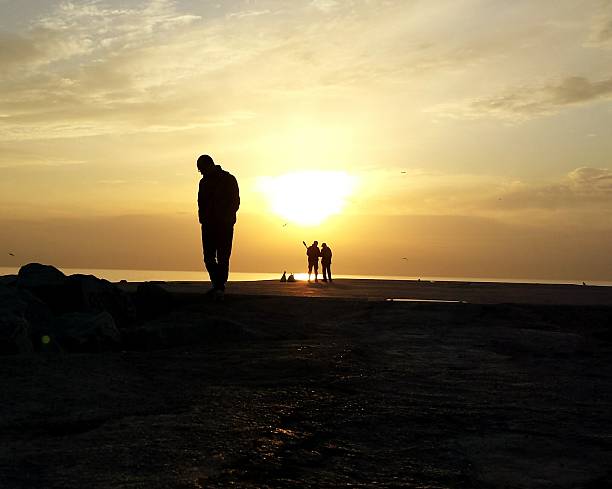 istock Silhouette People At Pier Against Sky During Sunset 636749407