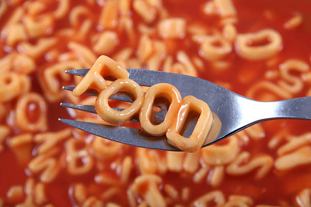 istock Spaghetti spelling the word 'food' with the letters on a fork. 636749624