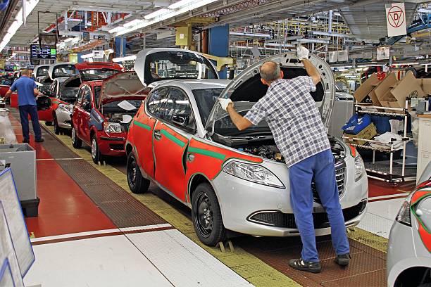 Cars production line Tychy, Poland - June, 16th, 2011: Cars production line in Fiat factory in Poland. The assembly plant ensures both the production of the Fiat range models (Panda II, 500), Lancia/Chrysler Ypsilon and Ford Ka. The manufacturing line was adapted for an annual capacity of 600,000 cars. lancia ypsilon stock pictures, royalty-free photos & images