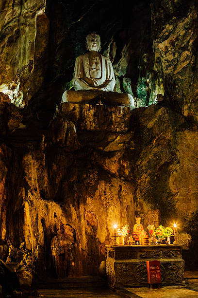 istock Stone Buddha inside the cave temple above an altar with 636751778