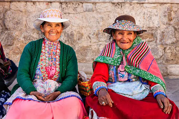 Peruvian women wearing national clothing waiting for a bus. Chivay is a town in the Colca valley, capital of the Caylloma province in the Arequipa region, Peru. Located at about 12,000 ft above sea level, it lies upstream of the renowned Colca Canyon. It has a central town square and an active market. Ten kilometers to the east, and 1,500 meters above the town of Chivay lies the Chivay obsidian source. Thermal springs are located 3 km from town, a number of heated pools have been constructed. A stone "Inca" bridge crosses the Colca River ravine, just to the north of the town. The town is a popular staging point for tourists visiting Condor Cross or Cruz Del Condor, where condors can be seen catching thermal uplifts a few kilometers downstream.http://bhphoto.pl/IS/peru_380.jpg