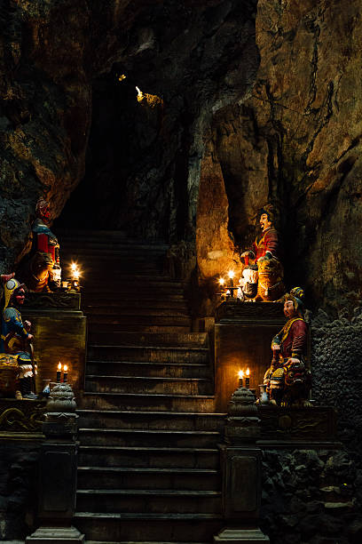 istock Atmospheric temple stone building in cave falls pillar sunlight, 636751868