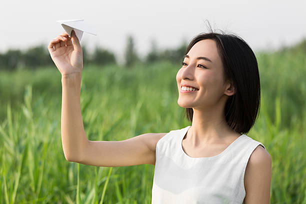 istock girl hands holding model airplane 636756798