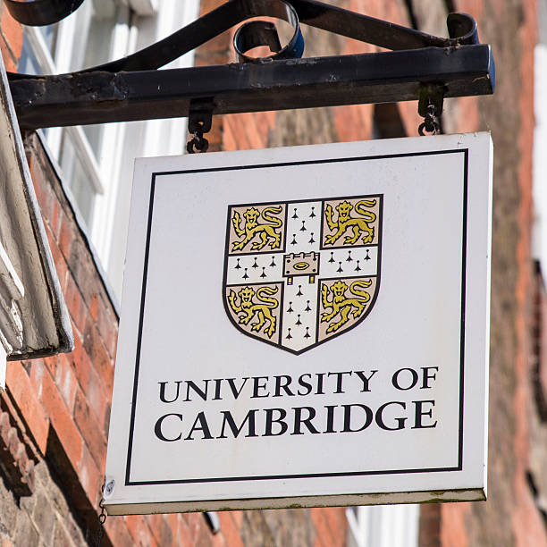 University of Cambridge Sign Cambridge, UK - July 18th 2016: A University of Cambridge sign located in Cambridge, UK. queens college stock pictures, royalty-free photos & images