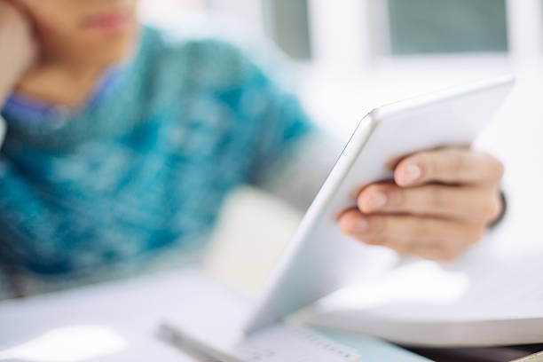 istock young asian man studying by tablet in classroom 636759102