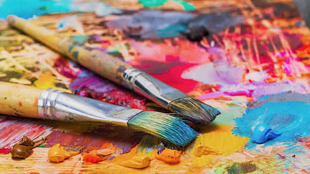 Used brushes on an artist's palette of colorful oil paint Used brushes on an artist's palette of colorful oil paint for drawing and painting education horizontal image colors stock pictures, royalty-free photos & images