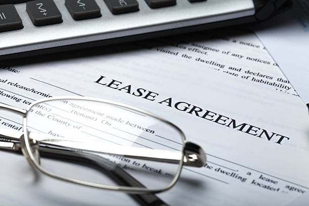 Business Lease Agreement Documents with Glasses, Pen and Calculator lease agreement stock pictures, royalty-free photos & images