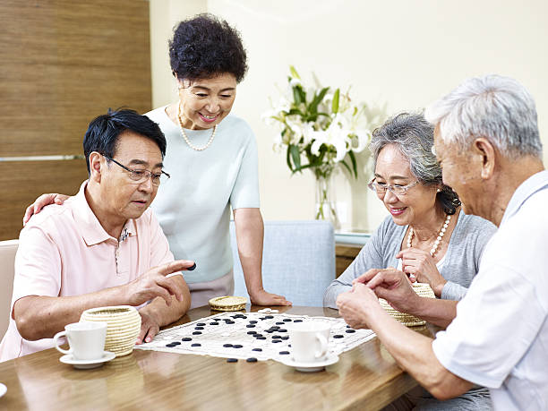 istock Senior people playing Weiqi at home 636762118