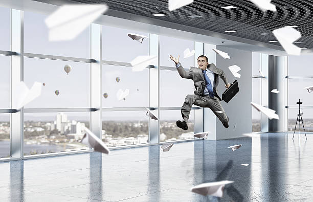 istock Dancing businessman in office room 636766288