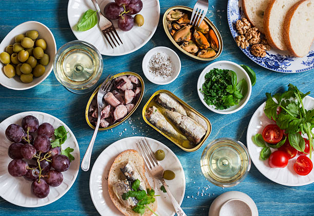 istock Snacks table - canned sardines, mussels, octopus, grape, olives, tomato 636769432