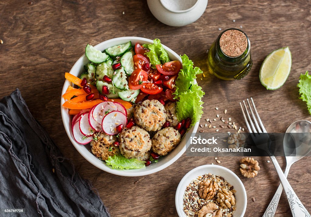 Baked quinoa meatballs and vegetable salad Baked quinoa meatballs and vegetable salad on a wooden table, top view.  Buddha bowl. Healthy, diet, vegetarian food concept. Flat lay Salad Stock Photo