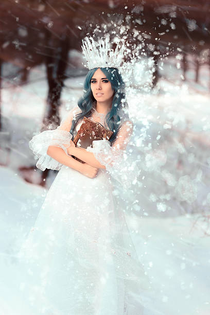 istock Snow Queen Holding Mirror in Winter Fantasy 636770098