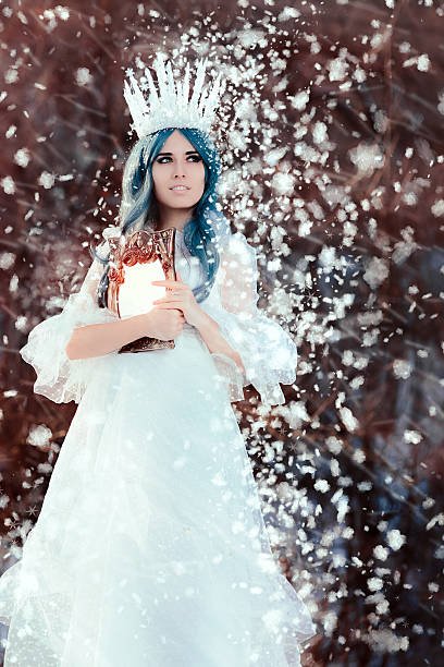 istock Snow Queen Holding Mirror in Winter Fantasy 636770114