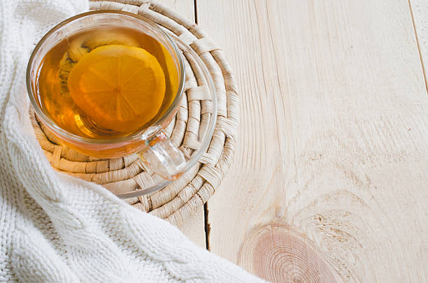 istock Cozy and soft winter background. Tea and warm knitted blanket. 636770288