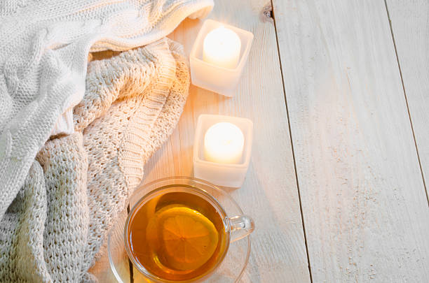 istock Cozy soft winter background. Warm sweaters, candles, cup of tea. 636771798