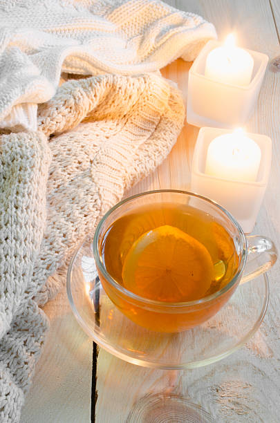 istock Cozy soft winter background. Warm sweaters, candles, cup of tea. 636771832