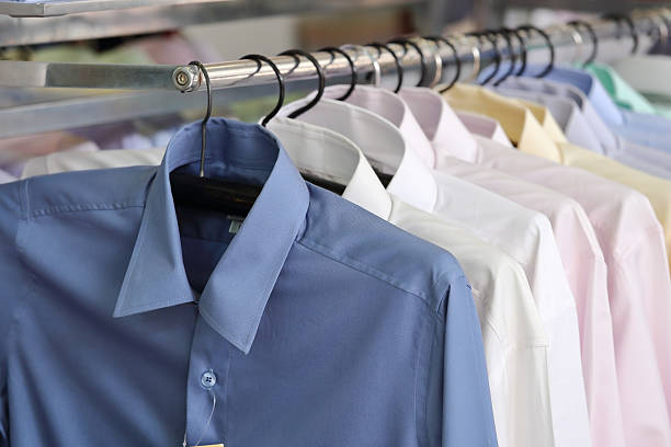 istock Mens plaid shirts on hangers in a retail store 636775440