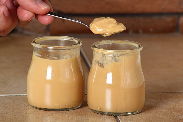 istock Eating milk pudding dessert in jar and cookies 636780716