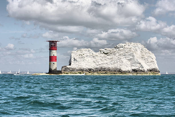 istock Red and white striped lighthouse at the needles 636780894