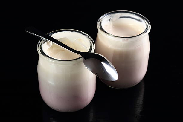 istock Yogurt with jam in open small glass jar with spoon 636782302