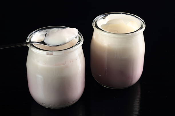 istock Yogurt with jam in open small glass jar with spoon 636782386