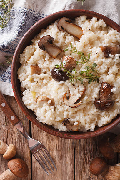 istock Italian rice with wild mushrooms closeup on the table. Vertical 636783094