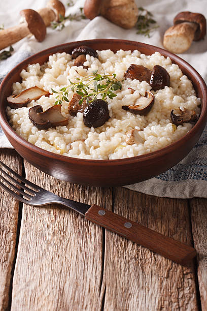 istock Italian rice with wild mushrooms close up on the table 636783286