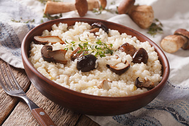 istock Italian rice with wild mushrooms close up on the table 636783350