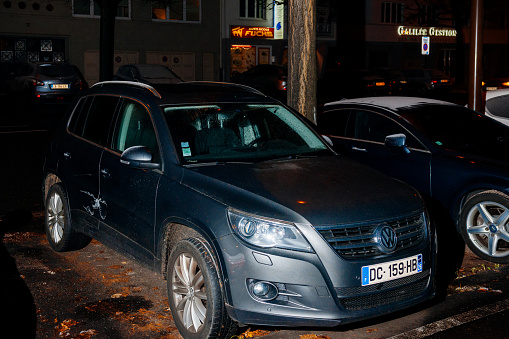 Strasbourg, France - December 6, 2016: Blue german Volkswagen Tiguan SUV car parked in the city covered with snow