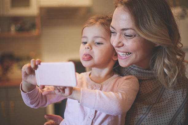 istock Mother with daughter making funny face. 636785530