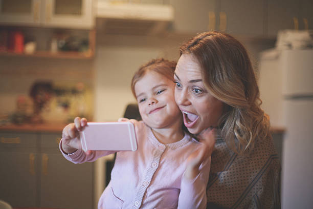 istock Mother with daughter making funny face. 636785738