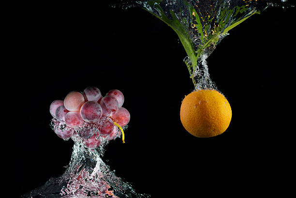 istock Fresh orange with green leaves in water with air bubbles 636786670