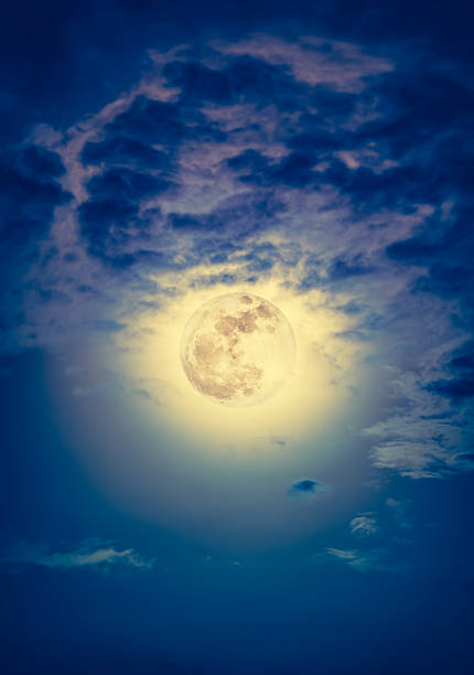 istock Nighttime sky with clouds and bright full moon with shiny. 636787448