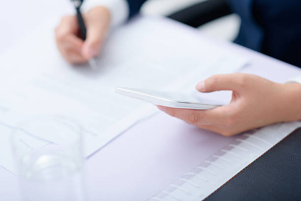 istock Businesswoman using smart phone work at desk. 636788692