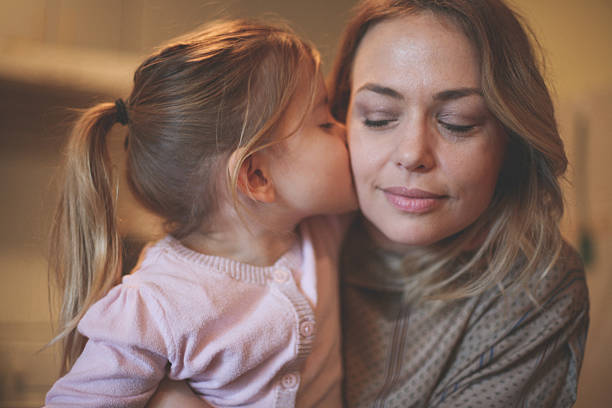 istock Daughter kissing her mother. 636789418