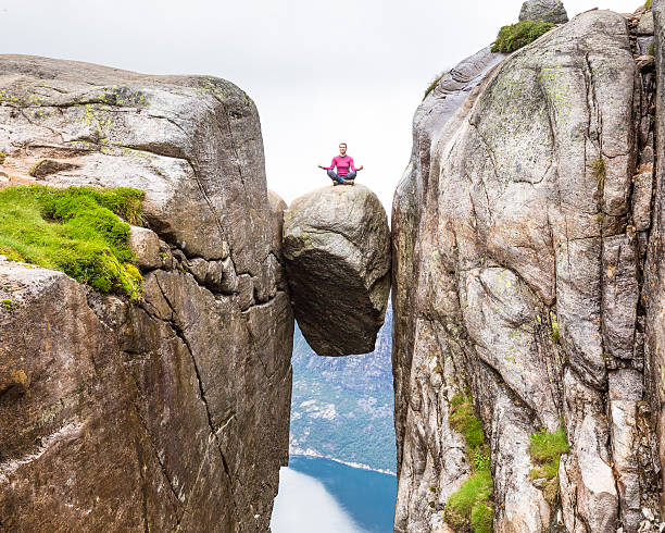 istock Happy tourist having fun on cliff in Norway 636789444