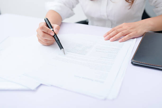 istock Business woman filling information on document. 636789730