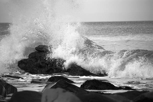 istock waves crashing over rocks on the sea shore 636792558