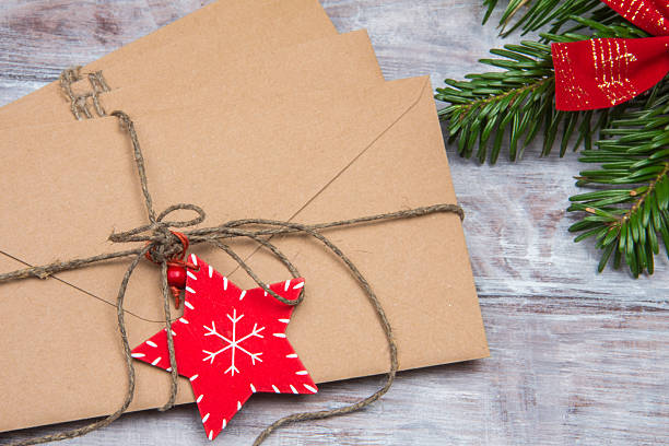 istock Christmas envelope with red star close-up on wooden background 636793134