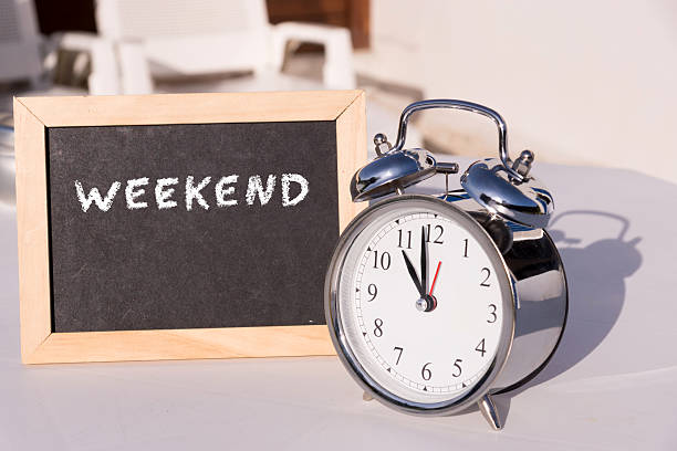 istock An alarm clock and a chalkboard with the word Weekend 636794116
