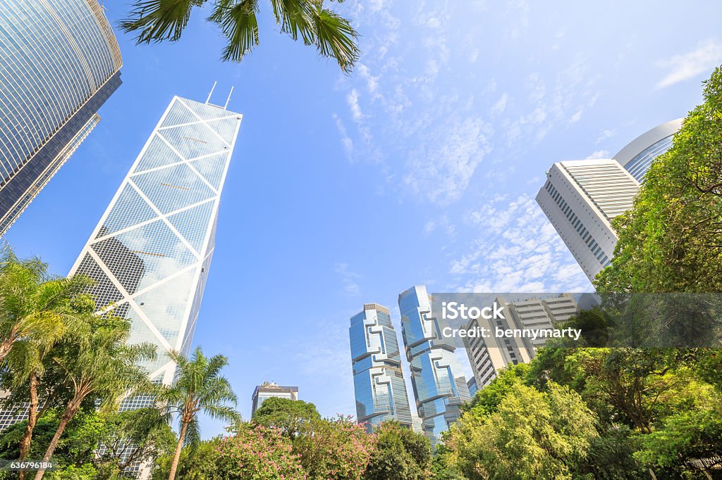 Hong Kong Park Skyline Skyline of modern skyscrapers and towers in the Central business district in a sunny day with blue sky seen from the Hong Kong Park, an oasis of peace in Hong Kong island. Architecture Stock Photo