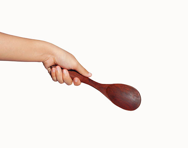 istock hand hold wood spoon isolated on white background 636796528