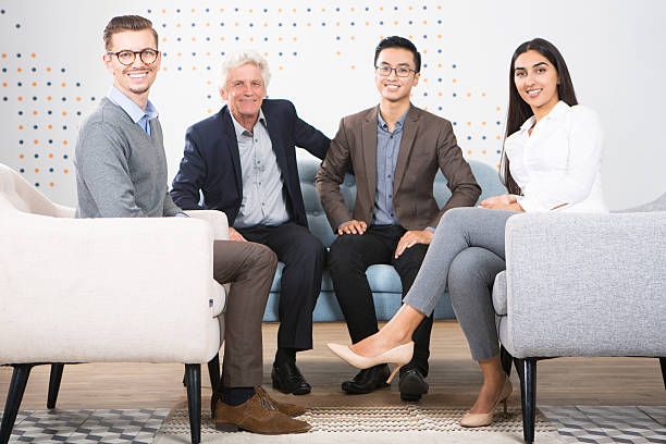 istock Four Smiling Diverse Business Partners in Lounge 636797732
